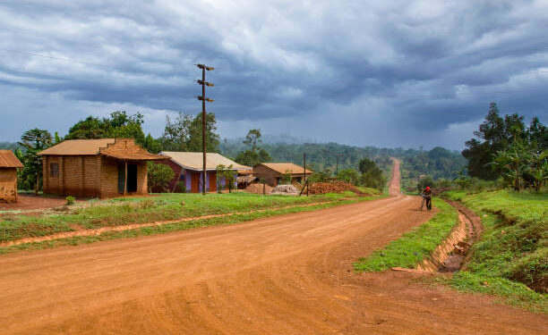 Cyclist on a dirt road in Africa.